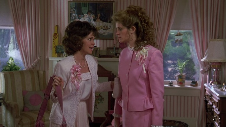 women talking in room with pink decor