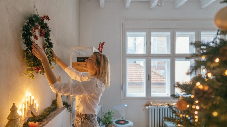 Woman decorating home for holidays