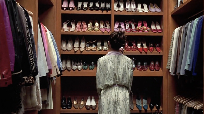 Woman standing with shoe rack