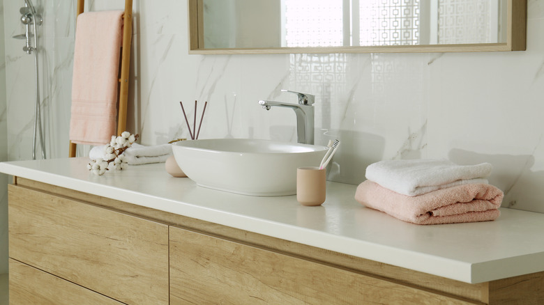 A wooden vanity with a bowl sink