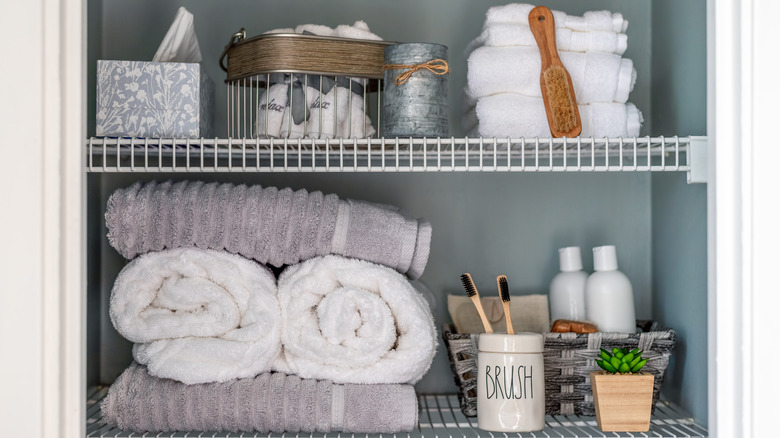 A bathroom linen closet with supplies