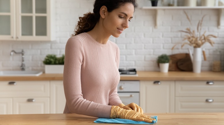 woman wiping kitchen counter