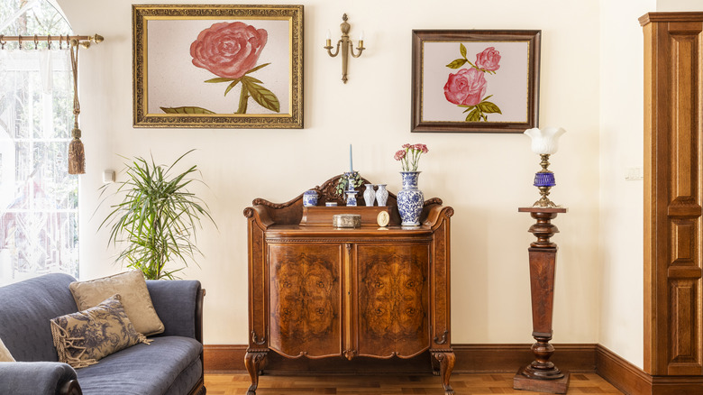 Southern style living room with blue couch, rose paintings and antique furniture