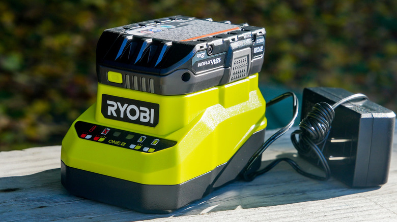 Ryobi battery and charger on a table outside