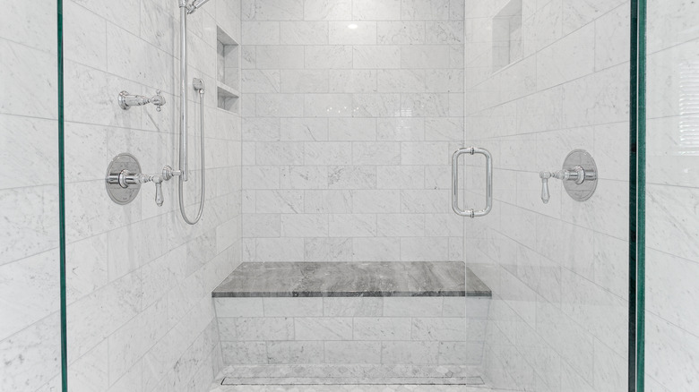 Marble shower interior with bench