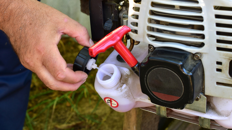 A two stroke string trimmer has oil mixed with the gas