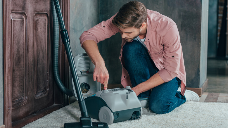 Man working on broken vacuum