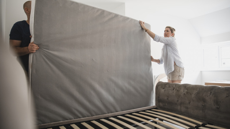 People removing old mattress