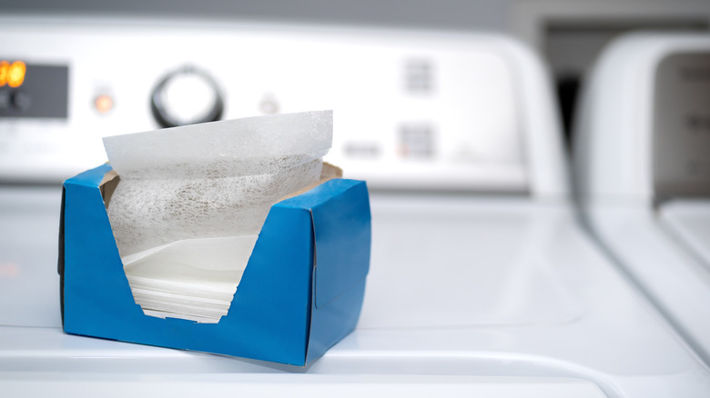 a box of dryer sheets sitting on top of a dryer