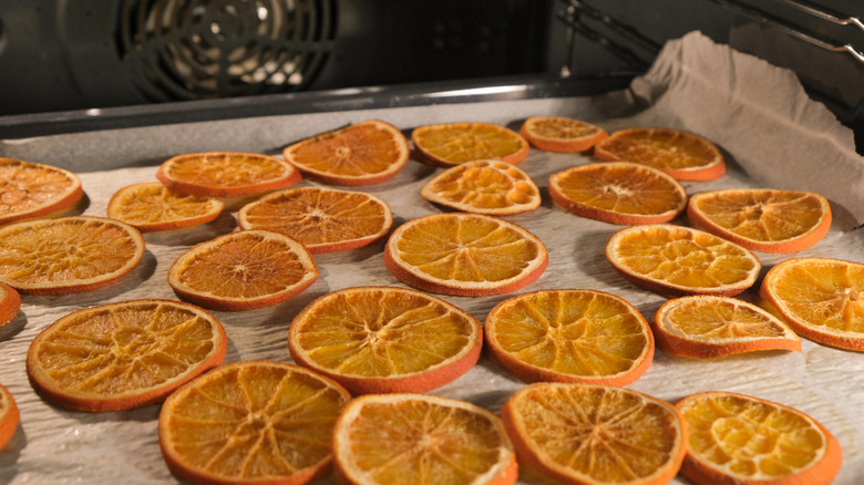 Dried orange slices on a baking sheet.