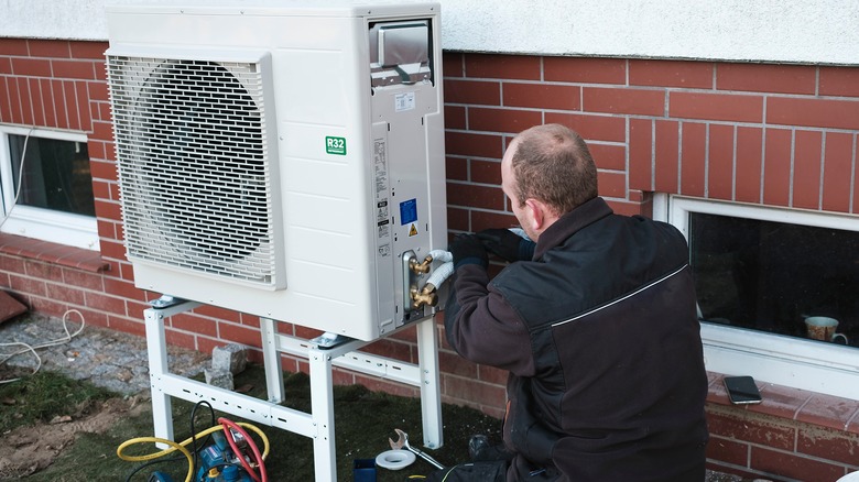 Man installing heat pump