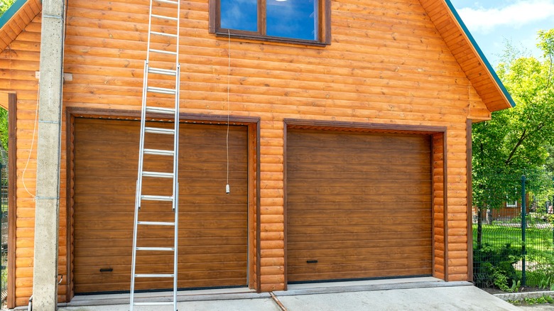 long extension ladder leaning against log garage