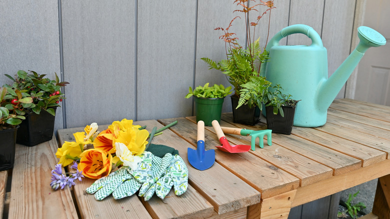 Wooden potting bench with tools on it