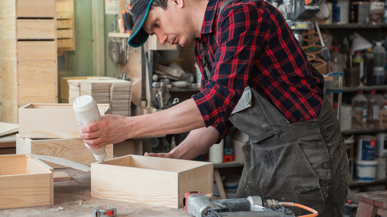 A man making wooden boxes