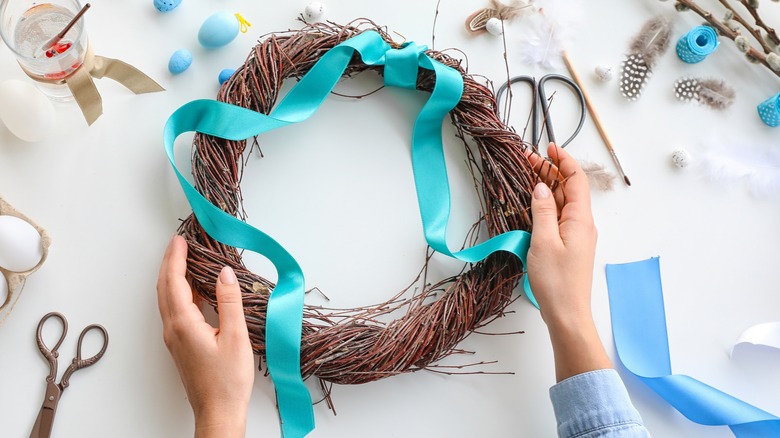 person making wreath