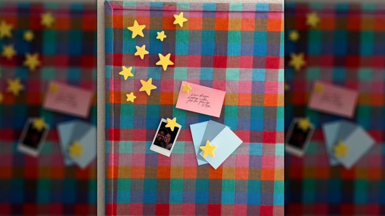 DIY colorful cork board featuring checkered fabric and cute star push pins