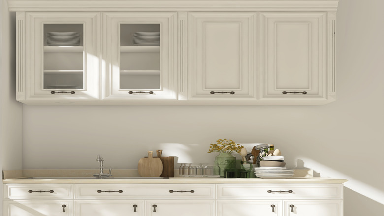 A set of kitchen cabinets with plates sit