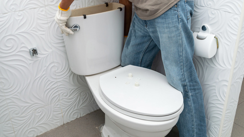 Man removing toilet