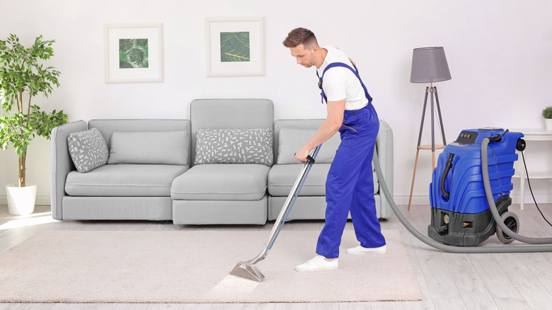 man cleaning carpet