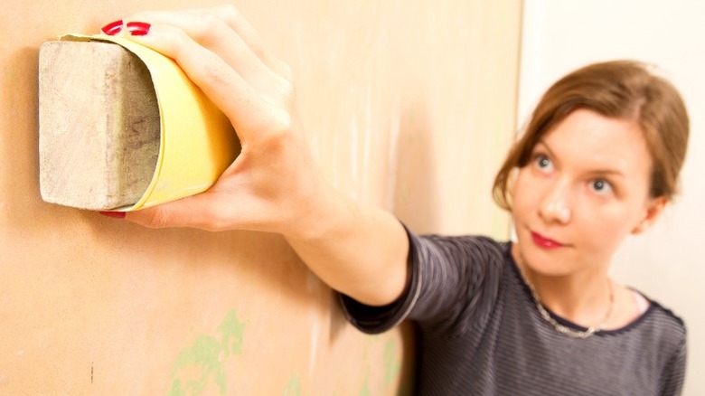 Woman holding dry cleaning sponge