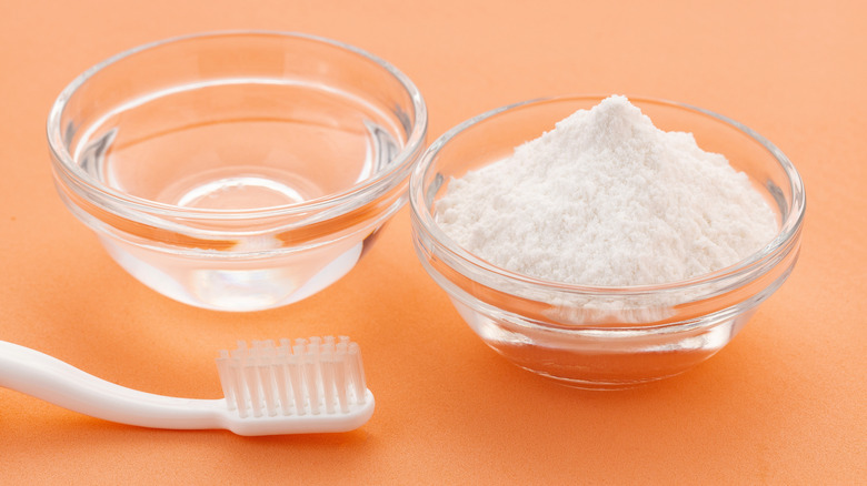 Baking soda and water in bowls with a toothbrush for cleaning