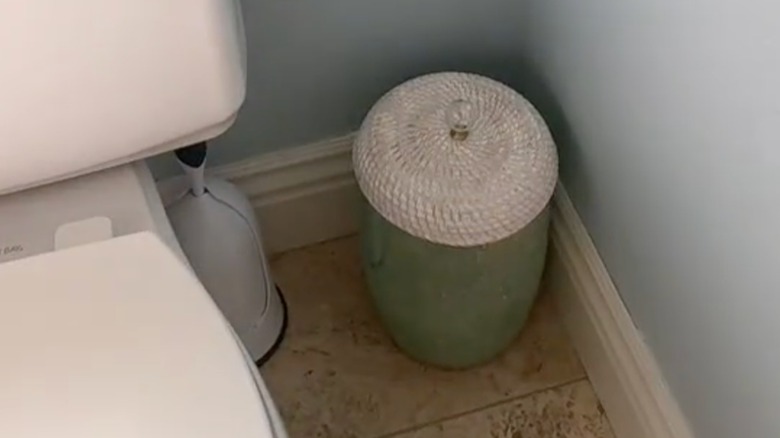 close up of DIY bin lid with white rattan tray and knob