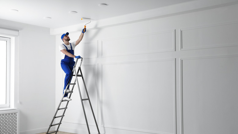 man painting a ceiling