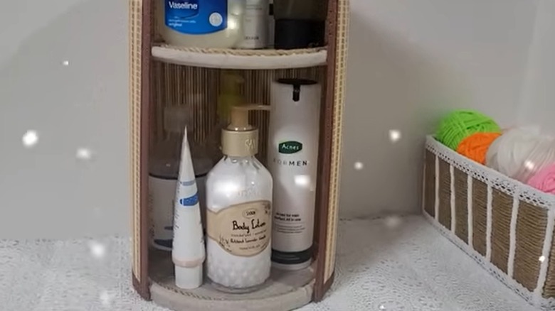 A DIY storage shelf made using plastic lids and a placemat