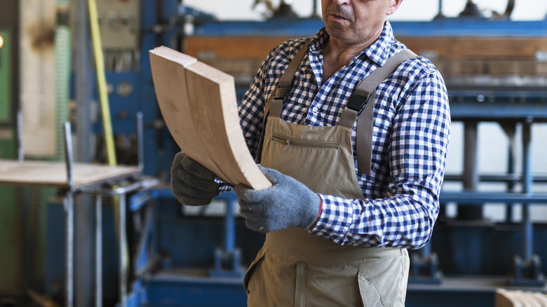 Woodworker holding bent wood boards