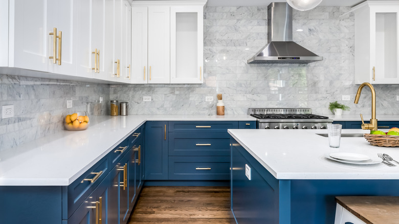 A luxurious kitchen with dark blue cabinets