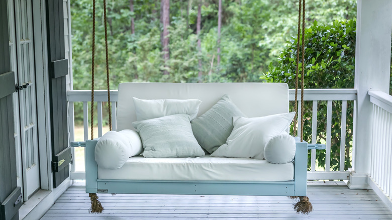 blue porch swing with ropes