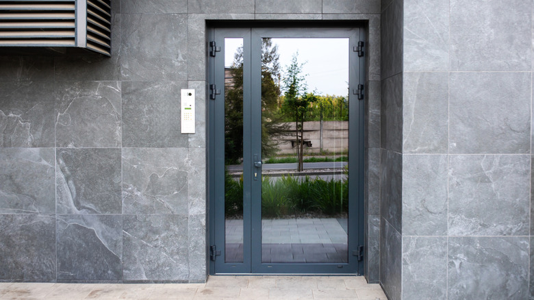 Modern gray stone home with all glass front door