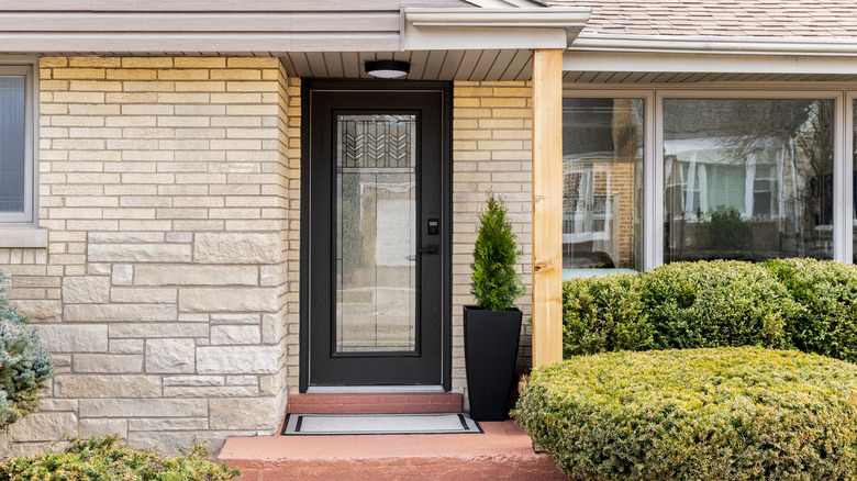 Brick and stone house with glass front door