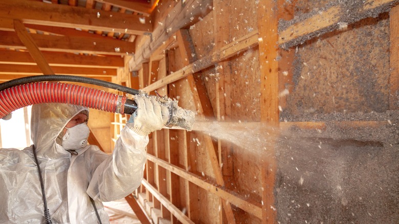 Person using insulation blower