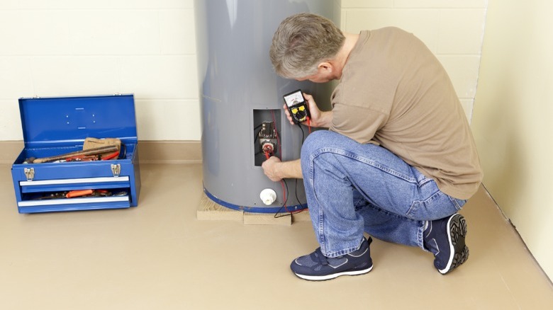 Man servicing hot water heater 