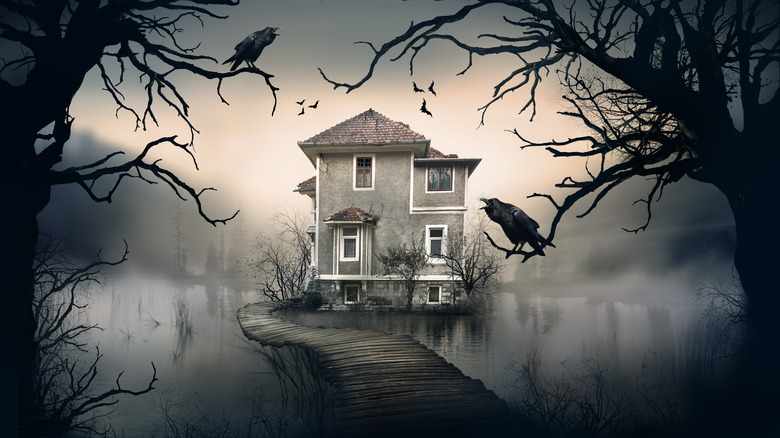 creepy house behind cawing ravens