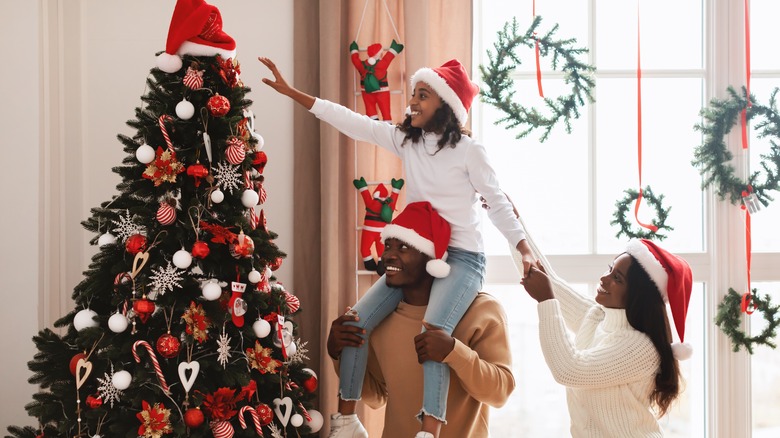 family decorating the Christmas tree