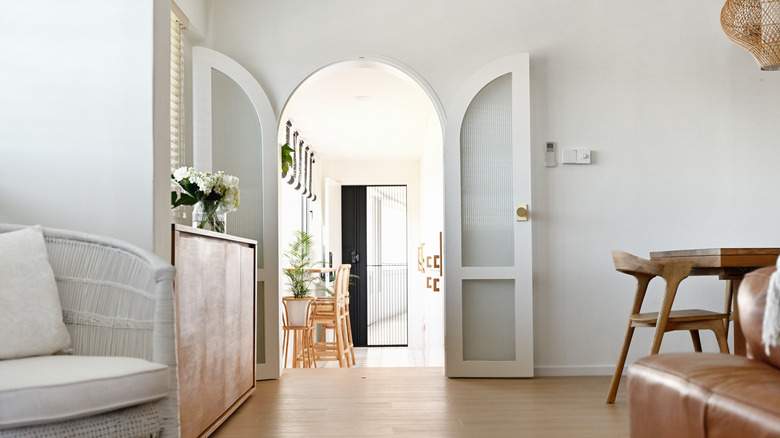 White room with arched double doorway
