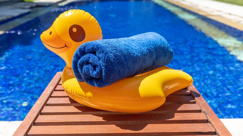 rolled towel on pool float