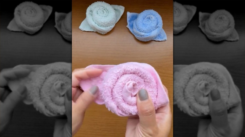 Blue, green, and pink towels shaped like roses