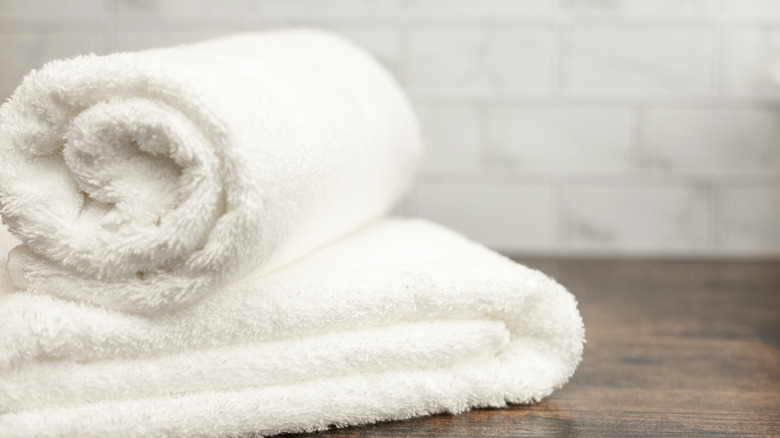 Two white bathroom towels on a counter