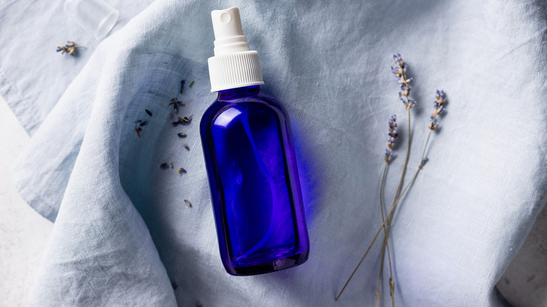 Blue spray bottle on linens