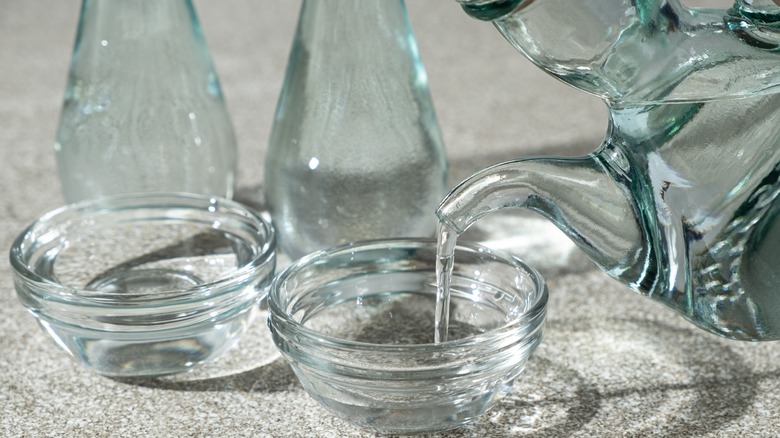 white distilled vinegar being poured into a glass