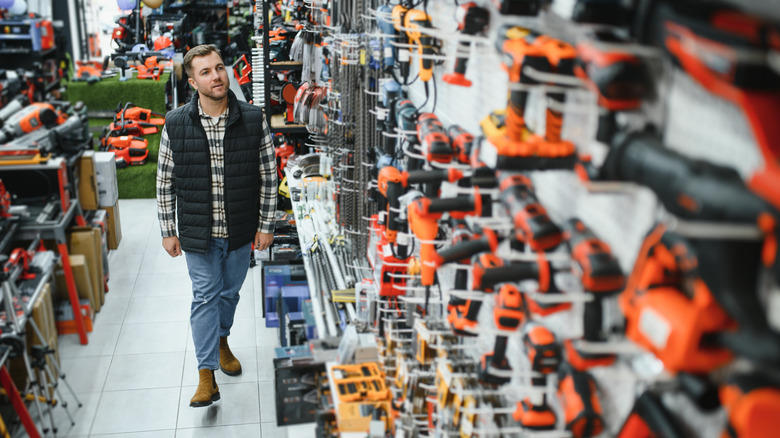 Person looking at wall of power tools in store