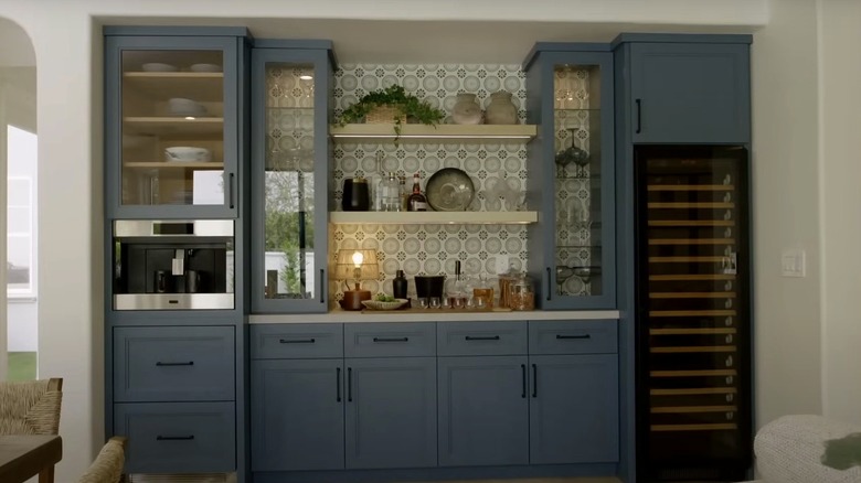 A large bar area features blue cabinets with glass doors