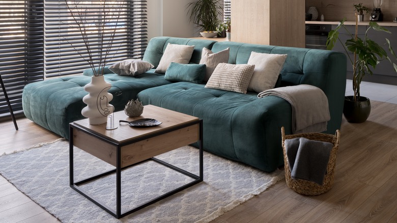 Large sea-green couch in apartment