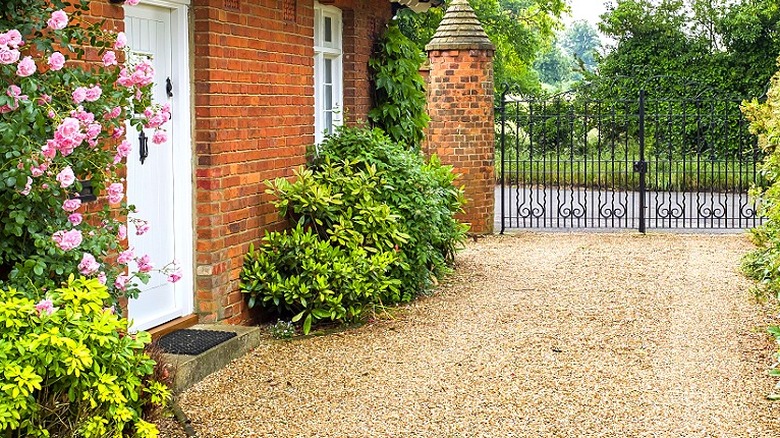 A gravel driveway in front of a home