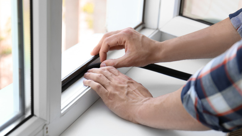 Person sealing window