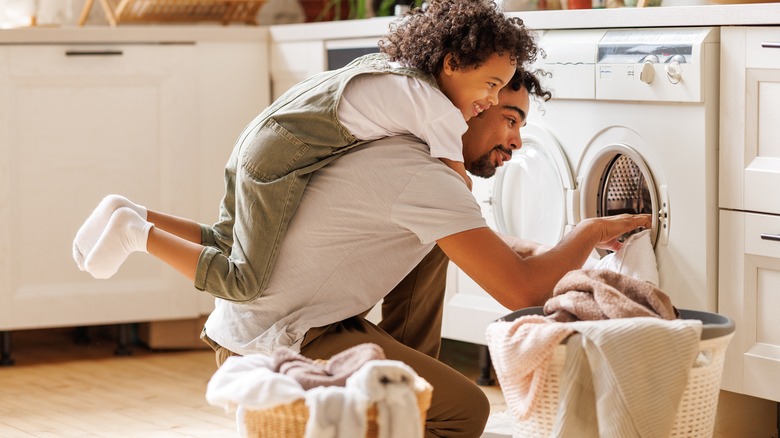 son and dad doing laundry