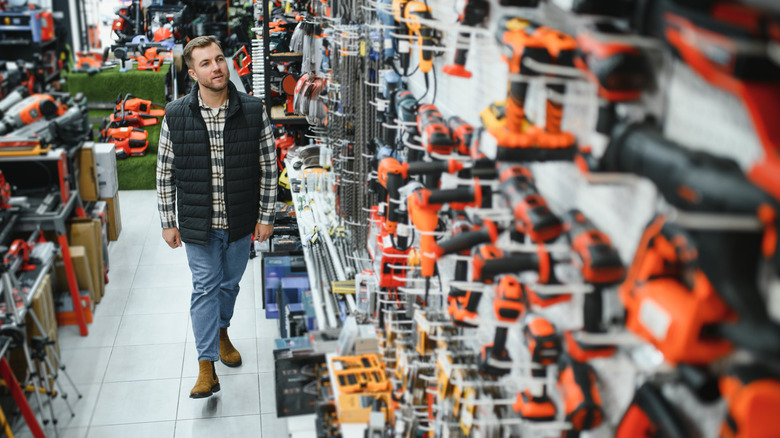 Man looks at power tools in store